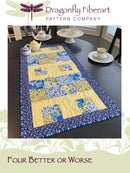 Quilted table runner on a dining table with Dragonfly Fiberart logo.