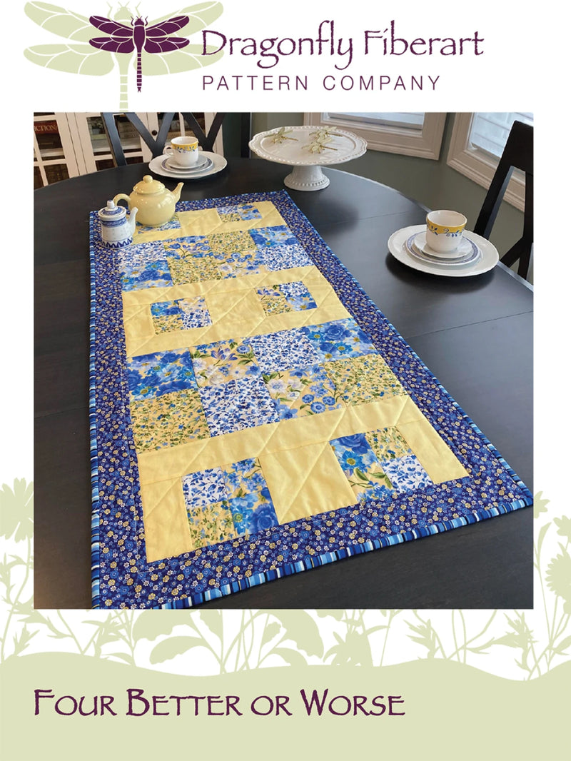 Quilted table runner on a dining table with Dragonfly Fiberart logo.
